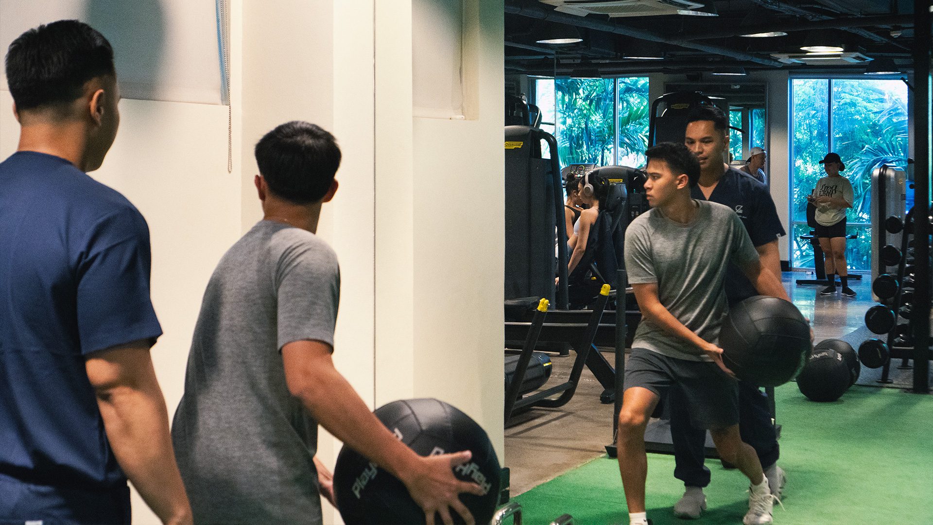 Members carrying wall balls across the training floor with a recovery team member among them.